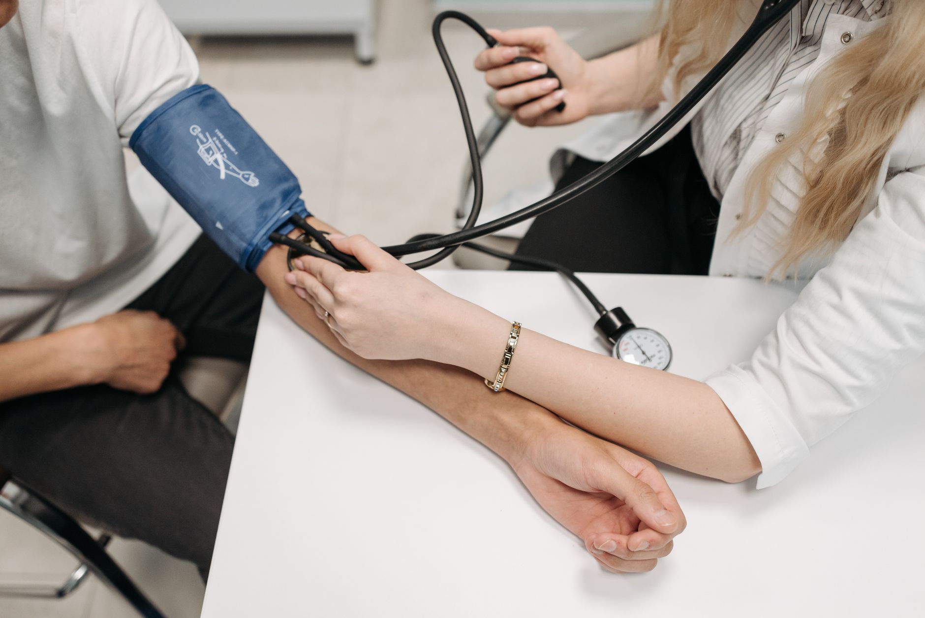 Médecin mesurant la tension d'un patient au bras