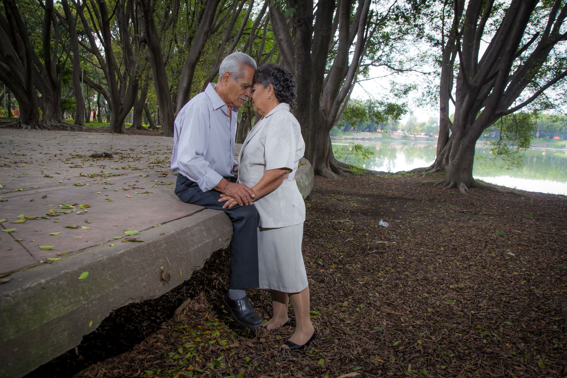 Couple senior s'enlaçant au bord d'un lac